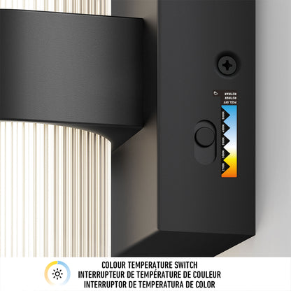 Close-up of the color temperature switch on the Artika Mirado modern LED wall sconce 5 CCT, featuring a sliding control for cool white to warm yellow; switch function labeled in English, French, and Spanish.