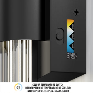 Close-up of the black adjustable color temperature switch on the Artika Dorado contemporary LED wall sconce, featuring a sliding selector for 3000K, 4000K, and 5000K. Below are labeled icons and instructions in English, French, and Spanish.