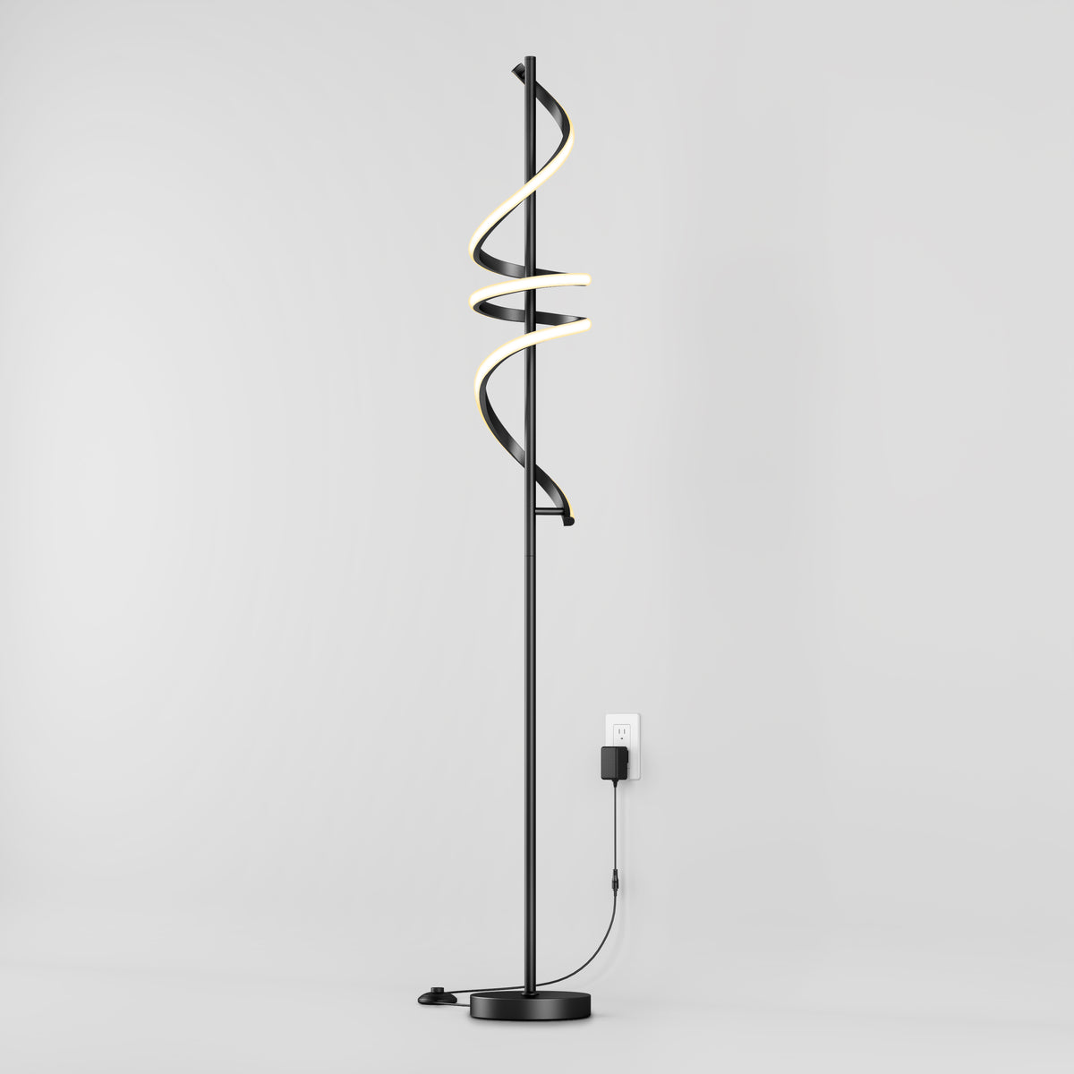 The Artika Coda modern LED floor lamp 5CCT features a spiral LED design, dimmable settings, and a round base, shown plugged in against a plain light gray background.
