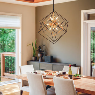 A modern dining room with a wooden table, large window, and the Artika Imperium 9-light chandelier above a geometric light fixture.