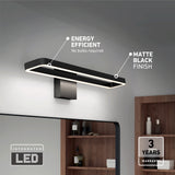 Modern rectangular LED wall light with a matte black finish mounted above a bathroom mirror; features include energy efficiency, no bulbs required, and a 3-year warranty. Shelves with towels and items are visible in the background.