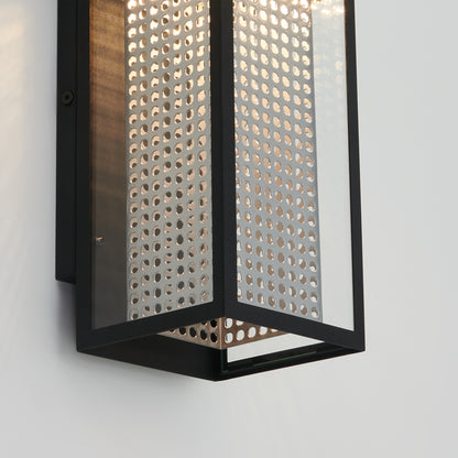 Close-up of the Artika Meteor LED indoor-outdoor wall light, featuring a black metal frame and perforated panel. Mounted on a light wall, it casts patterned illumination through its tiny holes.