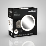 Black product box for an Artika Radia LED cosmetic mirror, featuring an image of the illuminated round mirror, details about its rechargeable feature, and branding on a light gray background.
