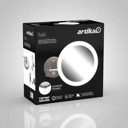 Black product box for Artika’s Radia Cordless LED Cosmetic Mirror, displaying an illuminated round mirror, product features, icons for LED lighting, rechargeable battery, 5x magnification, and mirror plus mounting options.