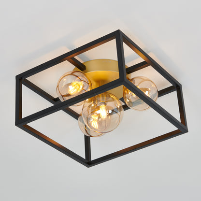 The Artika Griffintown flush mount is a modern ceiling light featuring a black square metal frame, gold base, and four exposed round bulbs.