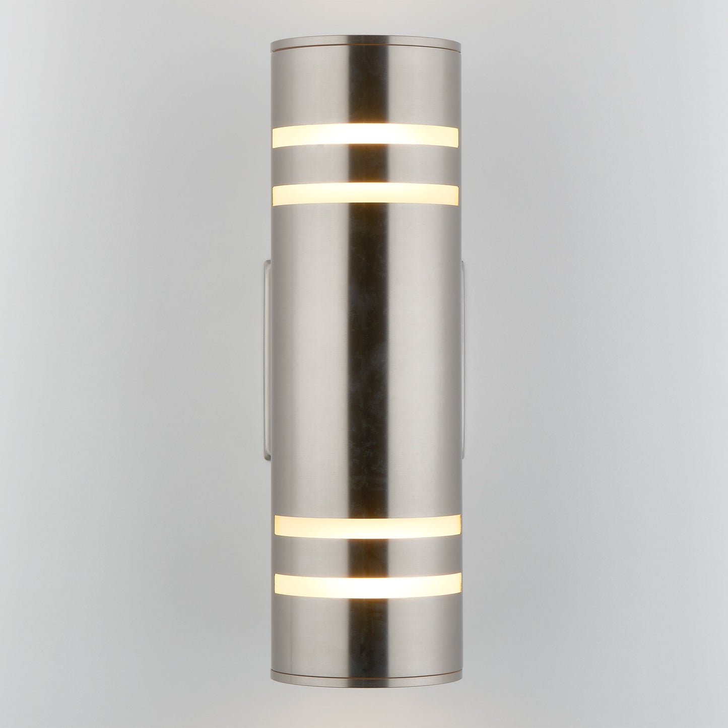 The Voltz indoor/outdoor wall light by Artika-CAN-dev is a modern cylindrical sconce with a brushed metal finish and frosted bands, mounted vertically on a white background to highlight its sleek, rust-resistant design.