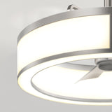A close-up of a modern ceiling fan with integrated circular LED lighting, featuring a metallic finish and sleek, minimalistic design against a light background.