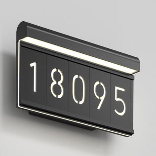 The Artika Bowen modern LED outdoor address wall light 5 CCT displays the number 18095 in black against a light gray wall, featuring white LED backlighting for a sleek, contemporary look.