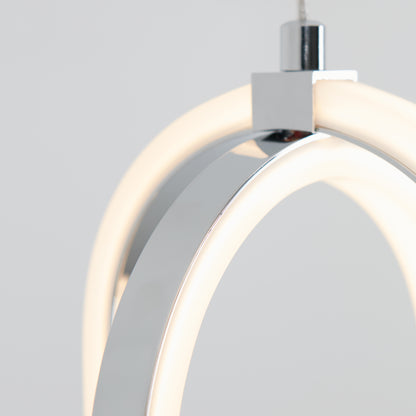 Close-up of the Arlo 1-light LED pendant by Artika, featuring a modern, minimal design with curved metallic elements and integrated LED lighting, set against a plain light gray background.