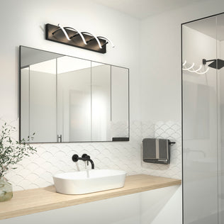 Modern bathroom with a large mirror, vessel sink, wood countertop, fish scale tiles, black fixtures, and an Artika DNA LED vanity light above.