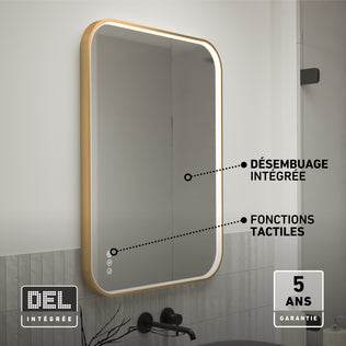 The Artika Royce Dimmable LED Mirror, 3 CCT, is mounted above a sink with a gold frame. Labels show integrated defogger, touch controls, adjustable colour temperature, and a 5-year warranty badge in the corner.