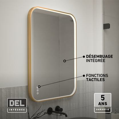 The Artika Royce Dimmable LED Mirror, 3 CCT, is mounted above a sink with a gold frame. Labels show integrated defogger, touch controls, adjustable colour temperature, and a 5-year warranty badge in the corner.