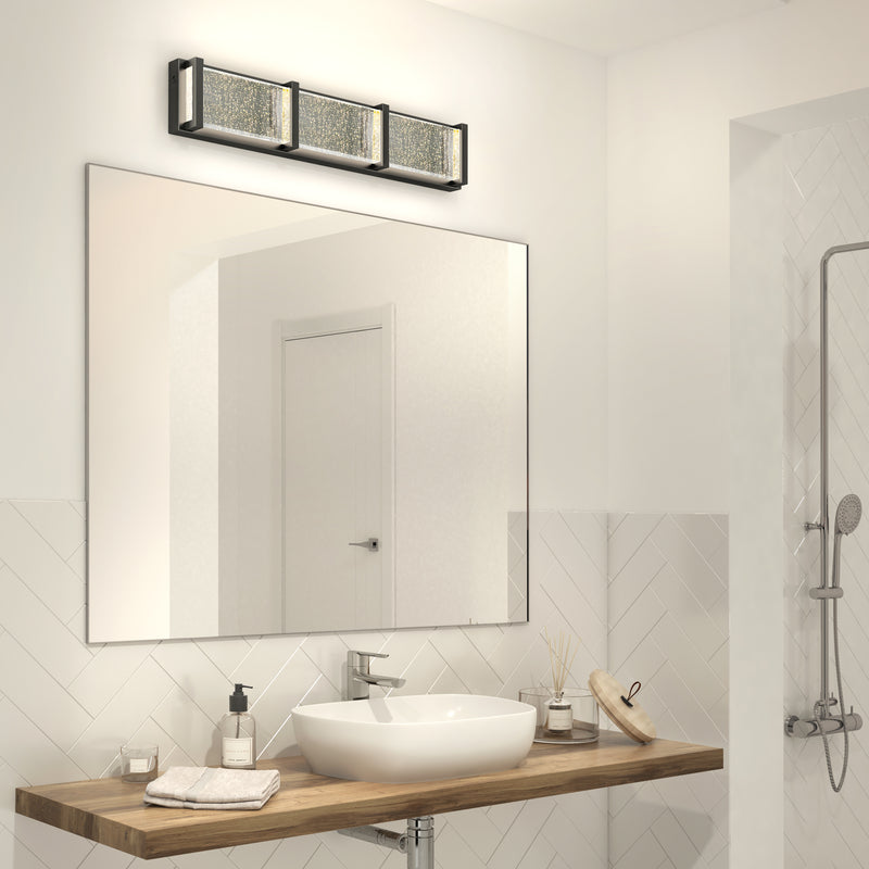 A modern bathroom with a vessel sink, wooden vanity, and an Artika Subway Essence 27-in integrated LED vanity light bar with tunable white technology mounted above a large mirror.
