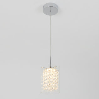 The Artika Crystal Cube 1-light LED pendant light features a chrome ceiling mount, slim cord, and cylindrical clear crystal shade that emits a soft glow, shown against a plain white background.