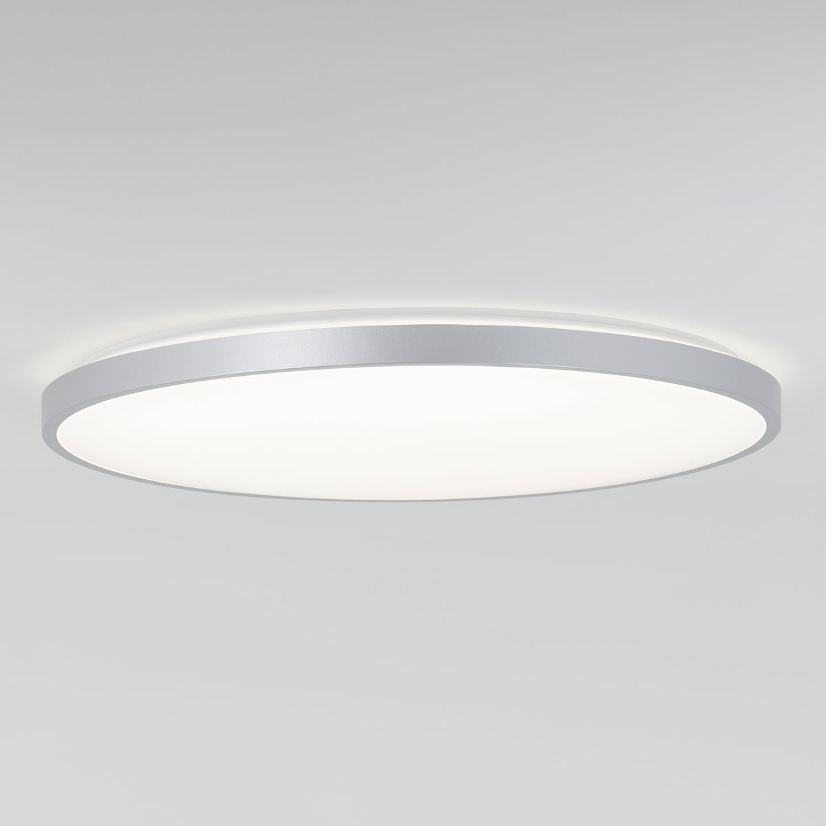 The Artika Jupiter 23 in. LED flush mount light features a silver rim, dimming presets, and comes with a remote for customizable lighting.