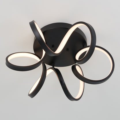 The Artika Swirl Ribbon flush mount light features black looping LED strips that emit a soft white glow, mounted on a circular base against a plain white ceiling.