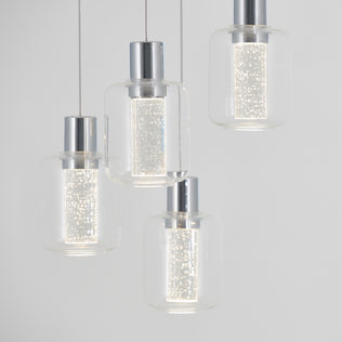 The Artika Champagne Globe 4-light LED pendant features modern metallic-topped clear glass shades hanging at varied heights, each emitting a sparkling, textured glow that softly illuminates any space.