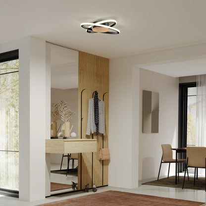 Modern, minimalist entryway with a wood accent wall featuring hooks, a console table with vases, a mirror, and the Artika Atomic 15 in. LED flush mount light overhead. The dining area is visible in the background.