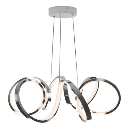 The Artika Swirl Ribbon LED pendant light features three intertwined LED rings with a sleek chrome finish, suspended by thin wires from a round ceiling mount, creating a soft white glow.