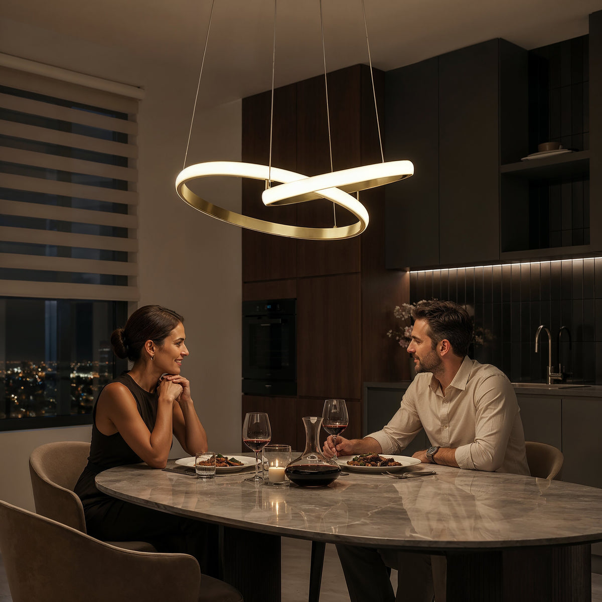 A couple dines at a modern table beneath the Artika Mora 28″ LED Pendant, featuring 5CCT dimmable lighting.