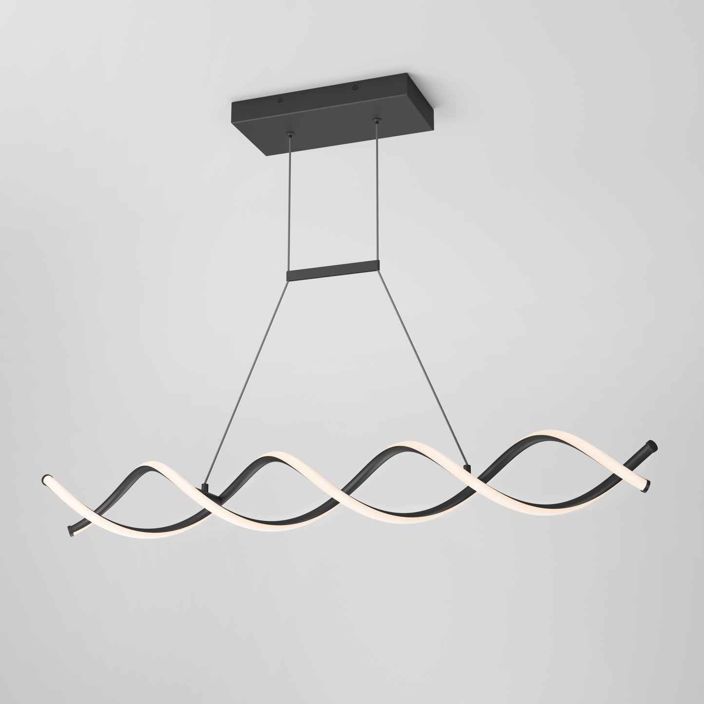 The DNA Linear LED modern pendant light by Artika-CAN-dev features two intertwined wave-like LED strips, one matte black and one glowing white, suspended by thin cables from a sleek rectangular black mount against a light grey backdrop.
