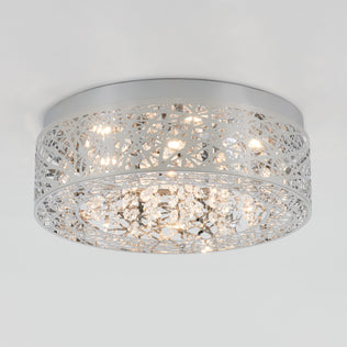 The Artika Crystal Nest LED flush mount is a modern ceiling light featuring a silver geometric lattice and hanging crystal accents, illuminated by multiple small bulbs.
