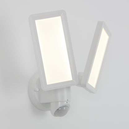 The Artika Sentinel outdoor Flat Panel Security light, a modern white dual-panel LED with motion sensor, is mounted on a white wall with both rectangular panels illuminated.
