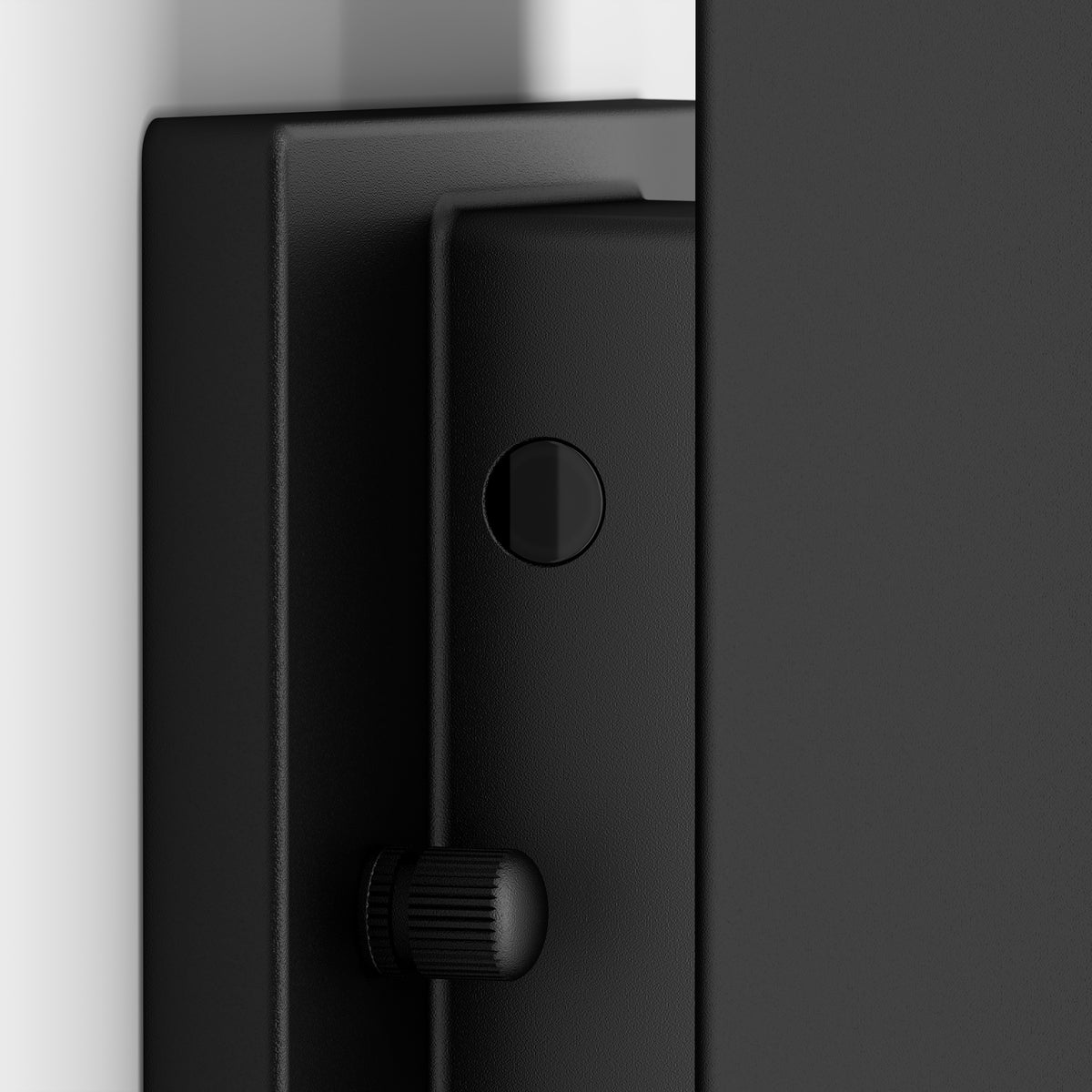 Close-up view of the Artika Linea Square LED indoor-outdoor wall light 3 CCT, a black fixture with a round button and textured knob, mounted against a white and gray background.