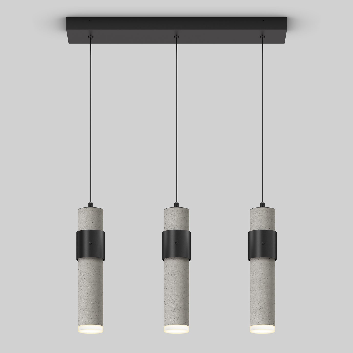 The Artika Barden 3-light LED pendant features cylindrical gray concrete bodies with black bands, suspended in a row from a rectangular black ceiling mount by thin black cords, set against a plain light gray background.