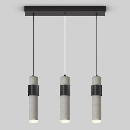 The Artika Barden 3-light LED pendant features cylindrical gray concrete bodies with black bands, suspended in a row from a rectangular black ceiling mount by thin black cords, set against a plain light gray background.
