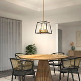 A modern dining area with a round wooden table, four black and cane chairs, a geometric pendant light, a plant, sheer curtains, and minimalist artwork on the wall.