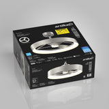 A black Artika ceiling fan box displays a modern silver ceiling fan with a circular LED light, technical specifications, and product features on the packaging. The fan image is shown prominently on the box.