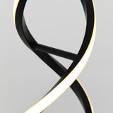 A close-up of a modern, abstract black lamp with a curving, twisted design and integrated LED light strip glowing softly against a plain white background.