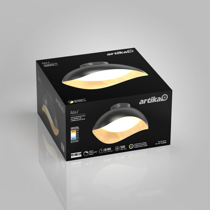 A black box displays the Artika Adara 15 in. LED flush mount light 5 CCT, a modern dome-shaped ceiling fixture with a wood-textured interior and white diffused light, set against a reflective gray background.