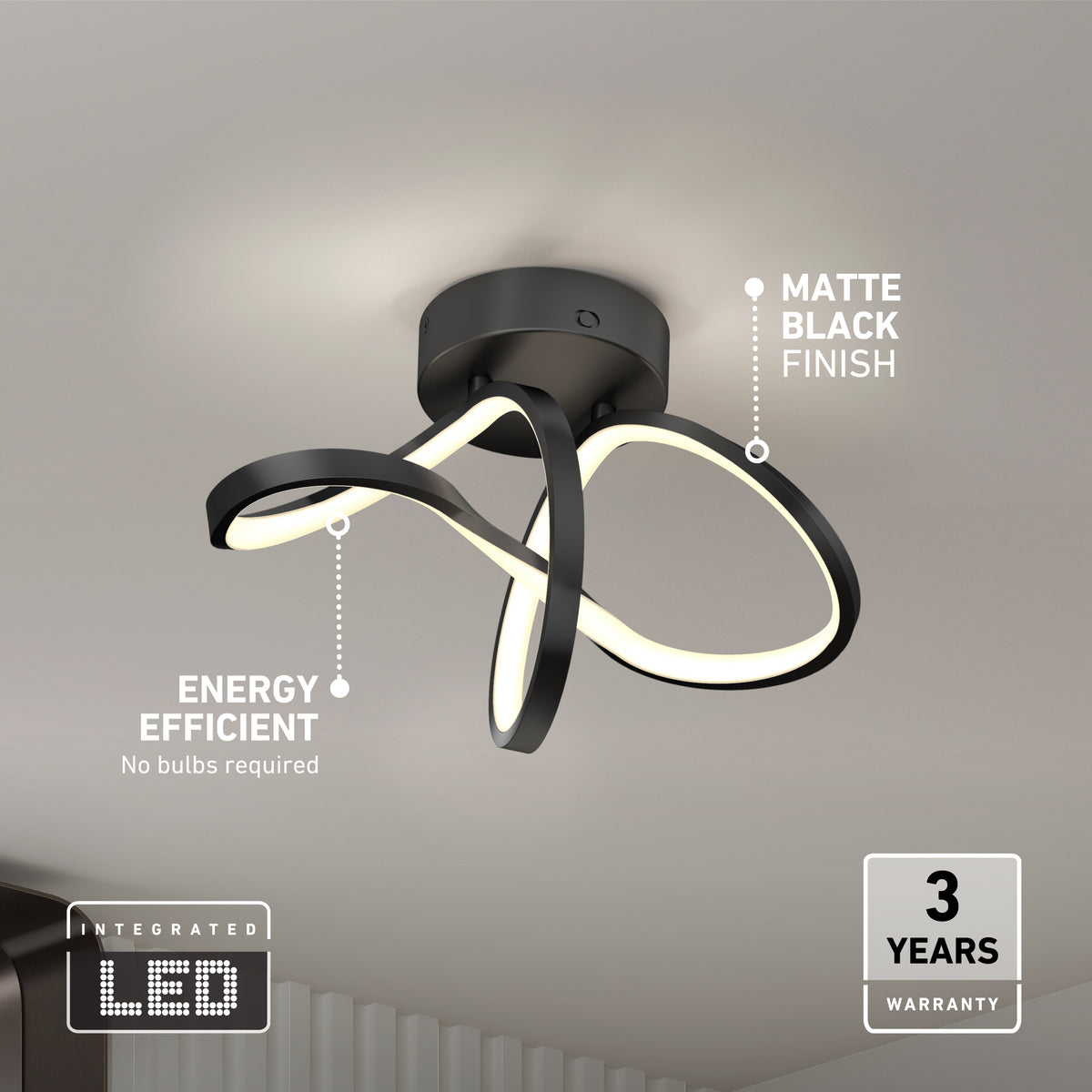 Modern ceiling light fixture with integrated LED, matte black finish, and a looping design. Text highlights energy efficiency (no bulbs required) and a 3-year warranty. Light is mounted on a white ceiling.