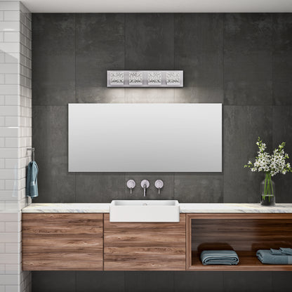 Modern bathroom with dark tiled wall, large mirror, white rectangular sink, wooden cabinetry, towel on a hook, vase of white flowers on the counter, and the Artika Bubble Cube 4-light LED vanity light above the mirror.