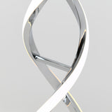 Close-up of a modern, sleek, metallic light fixture with a twisting, ribbon-like design, featuring a bright white illuminated edge against a plain light grey background.