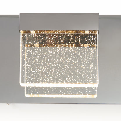The Artika Bubble Cube 4-light LED bathroom vanity light features a modern rectangular chrome base and clear acrylic shades with embedded bubbles, creating a sparkling lighting effect.