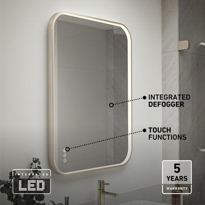 The Artika Royce Dimmable LED Mirror, 3 CCT, mounts horizontally or vertically. It features integrated lighting with adjustable colour temperature, touch controls, and a built-in defogger. A 5-year warranty is highlighted; sink and plant partially shown below.