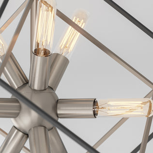 Close-up of Artika’s Imperium 9-light chandelier, featuring exposed bulbs and a geometric metal frame against a plain background.