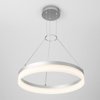 The Artika Optical LED pendant light 3 CCT features a modern circular design with a metallic frame, suspended by three thin wires from a plain, light gray ceiling, emitting a soft, even glow.