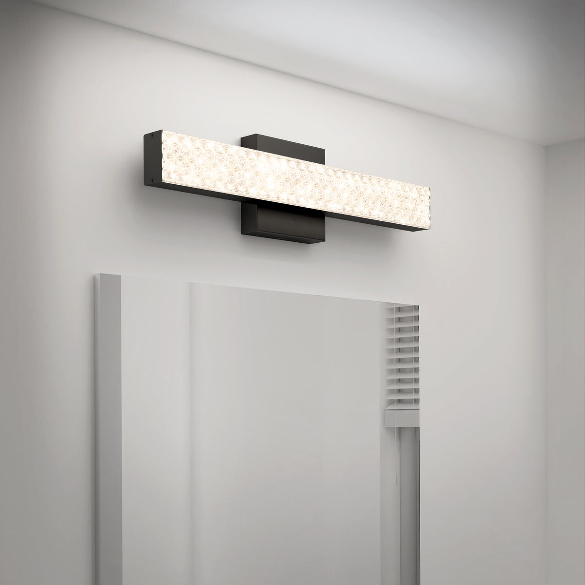 The Adeline modern LED bathroom vanity light 3 CCT by Artika is mounted above a large mirror in a minimalist bathroom.