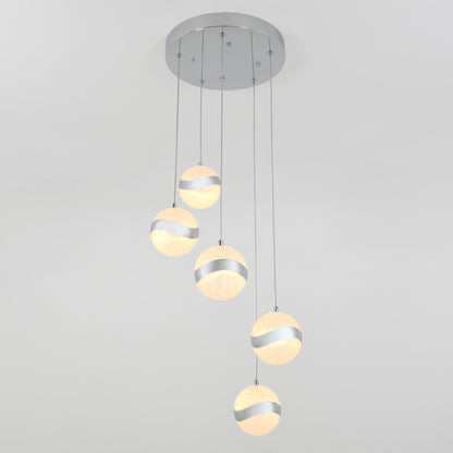 The Artika Wavey 5-light LED pendant is a modern ceiling fixture featuring five spherical lights with metallic stripe designs, suspended at varying lengths from a round silver base.