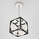 A modern ceiling light fixture with a black cubic frame enclosing circular LED lights, suspended from a metallic ceiling mount on a rod, set against a plain white background.