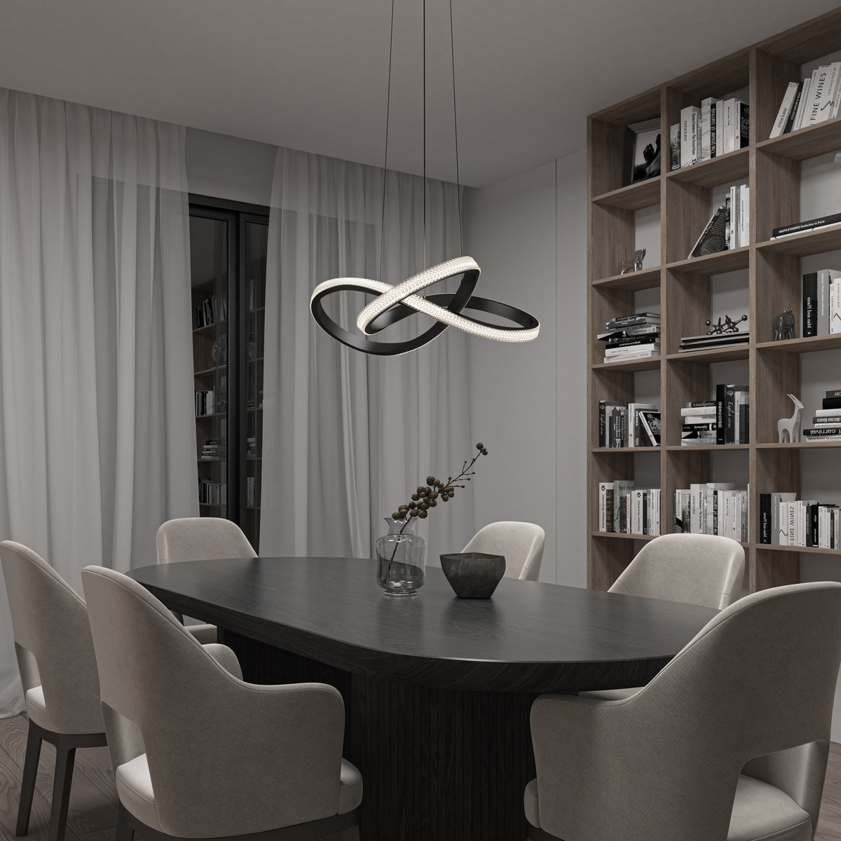 A modern dining room with a dark oval table, six light upholstered chairs, a vase with dried flowers, a geometric pendant light, floor-to-ceiling bookshelf, and sheer curtains over sliding glass doors.