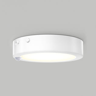 The Artika Accent under cabinet LED light 3CCT features a smooth, white finish, a side button, and a discreet motion sensor, casting a gentle glow against a light gray background.