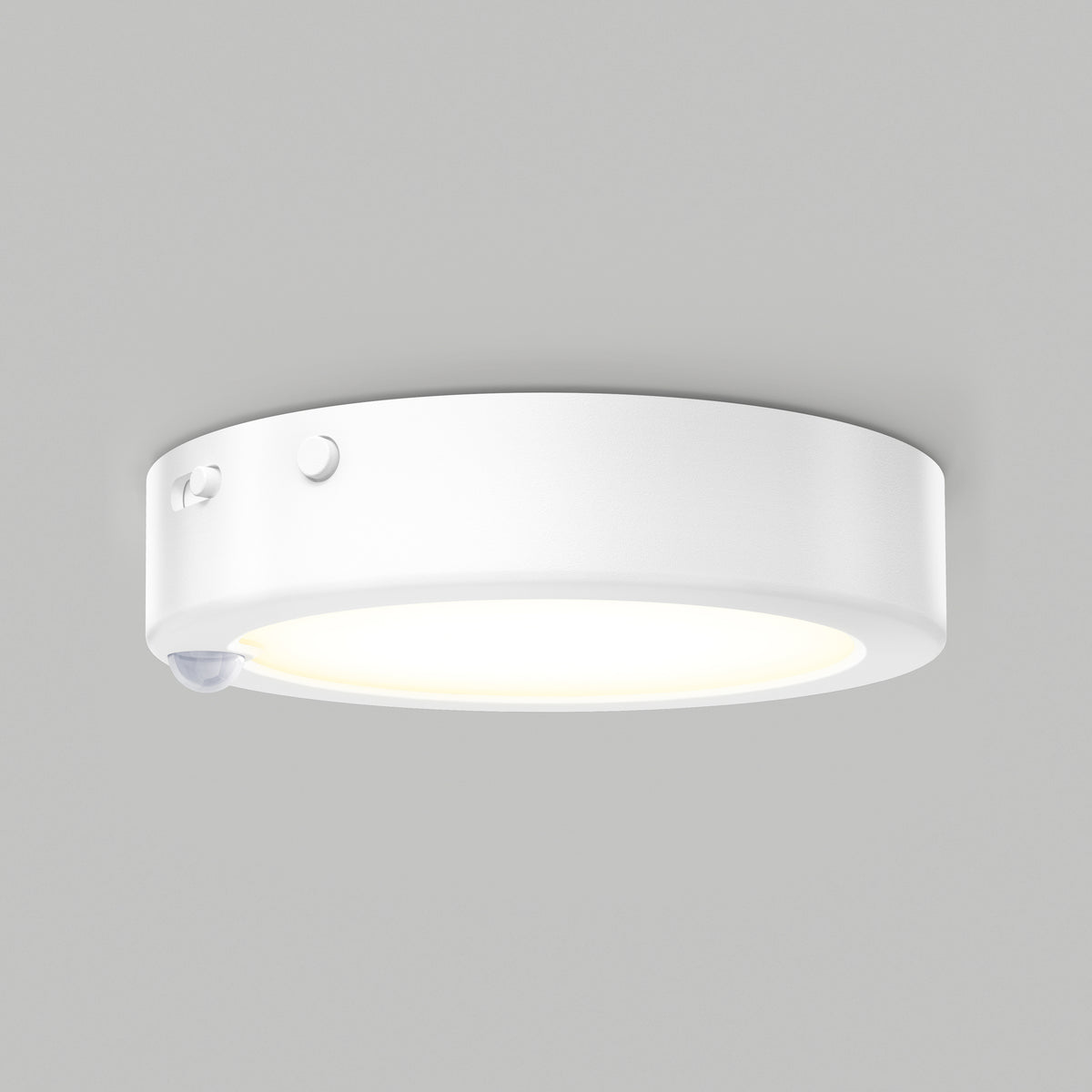 A round, white ceiling-mounted LED light fixture with a motion sensor and two small buttons on its side, shown against a plain gray background.