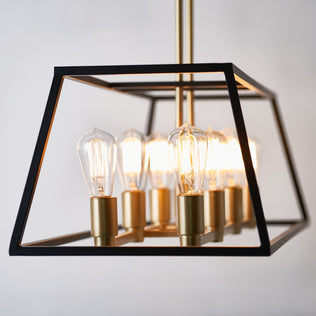 Artika Carter Long 8-light chandelier with exposed Edison bulbs, black frame, gold holders, and ceiling-hung LED pendant fixture.
