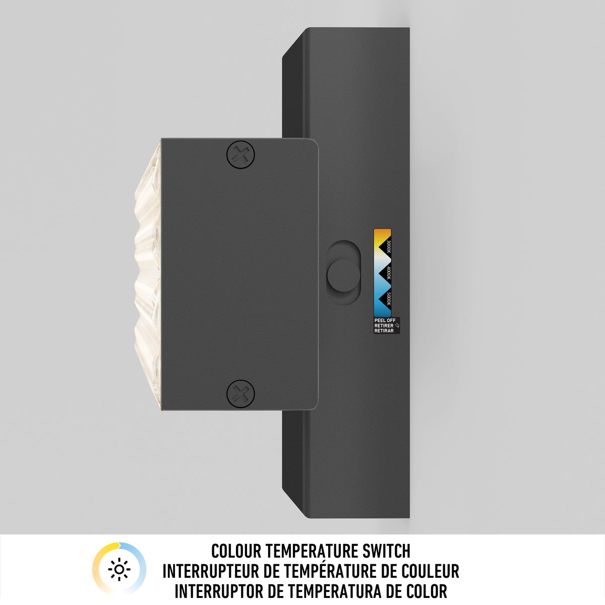 A black rectangular wall switch with a colour temperature control dial is mounted vertically on a light grey wall. A label indicates Colour Temperature Switch in English, French, and Spanish.