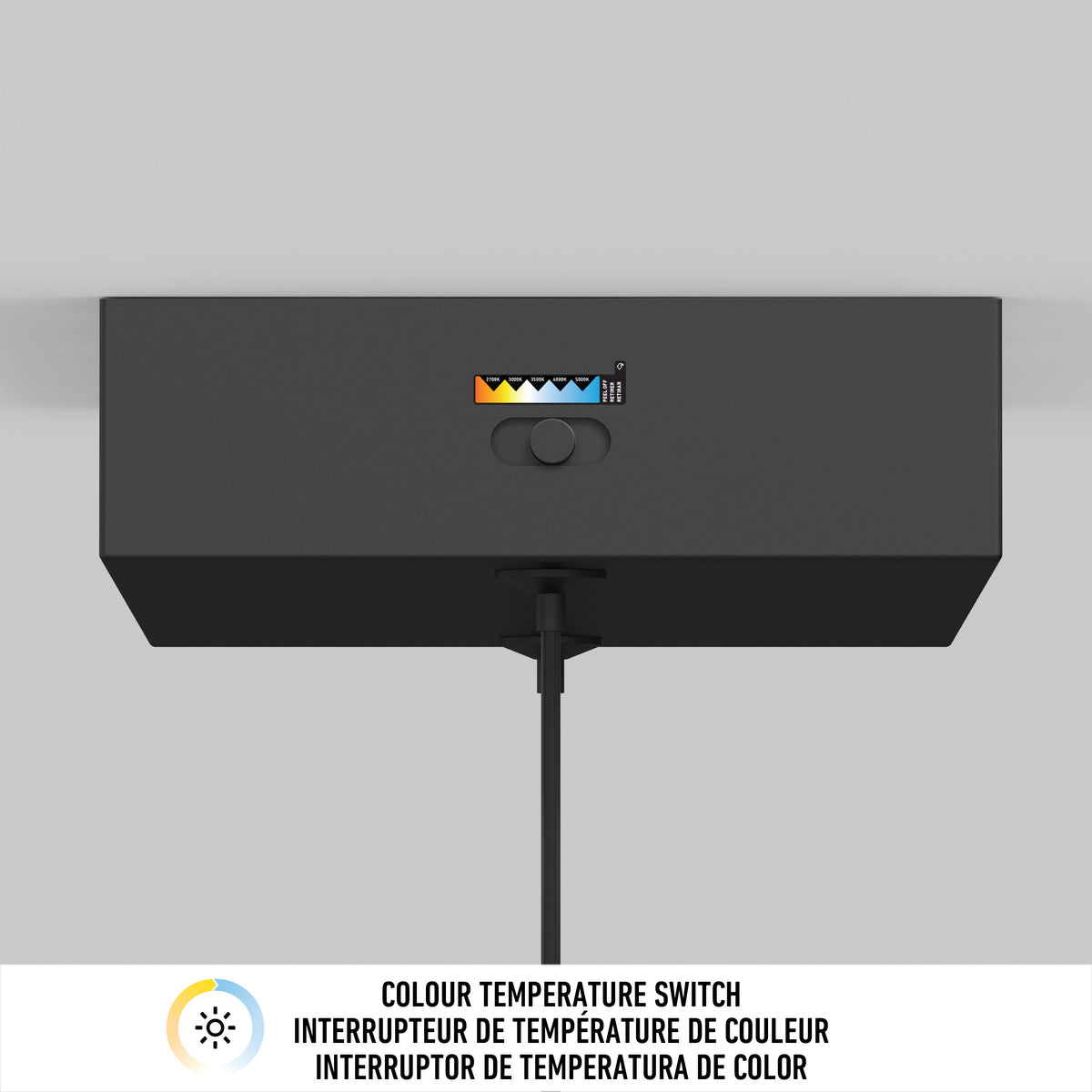 A black rectangular device with a color temperature switch showing five settings, mounted on a wall with a cord hanging down. A label below reads COLOUR TEMPERATURE SWITCH in English and two other languages.
